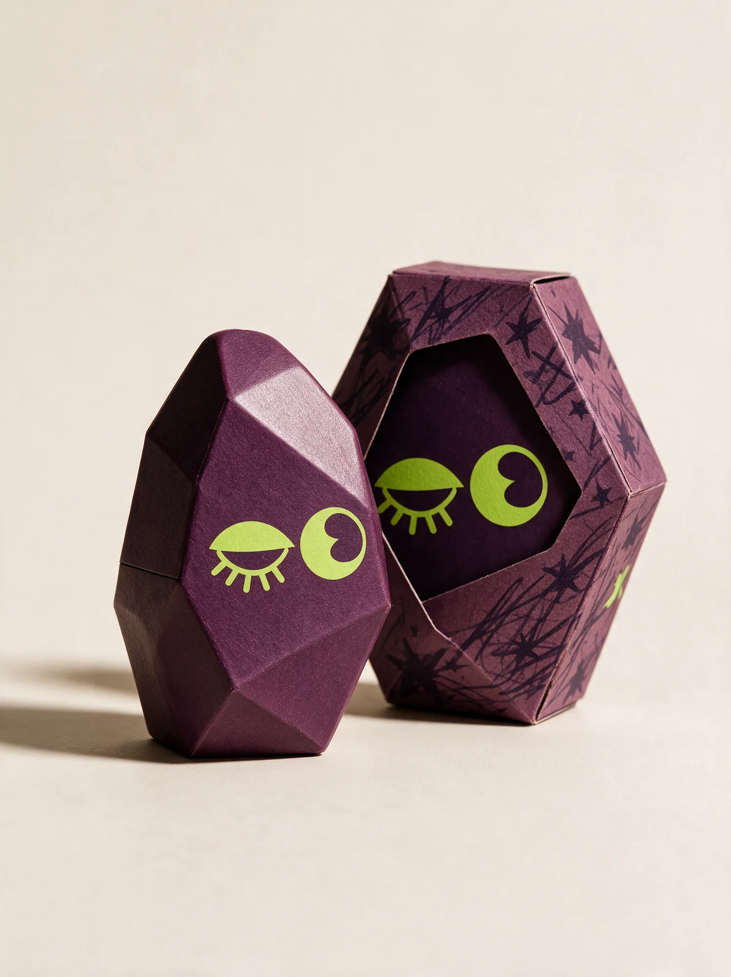 Faceted plum gem carton, open, lime eyes printed on both halves
