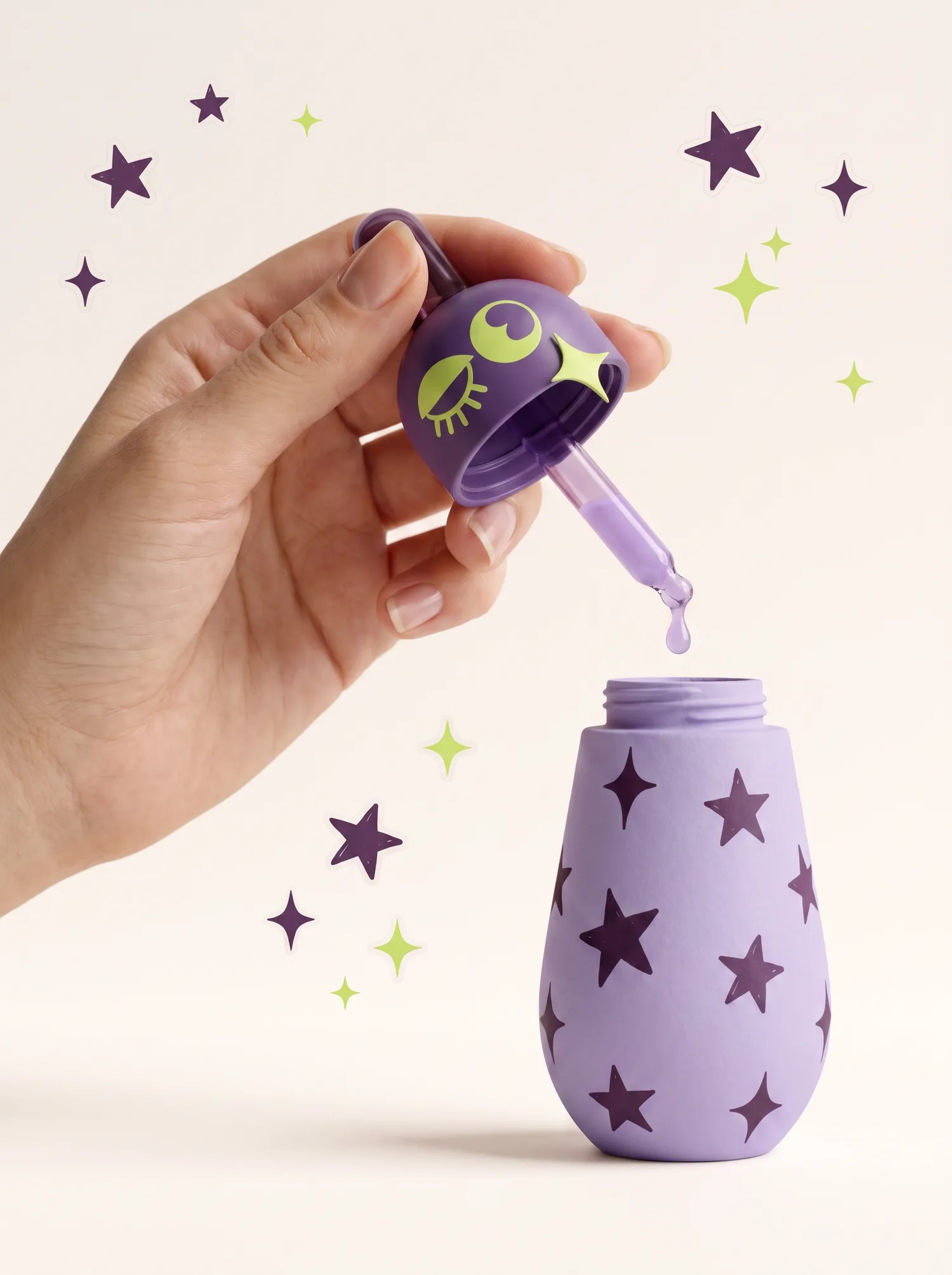 A hand lifting the dropper cap off a star-printed Fizzlé jar