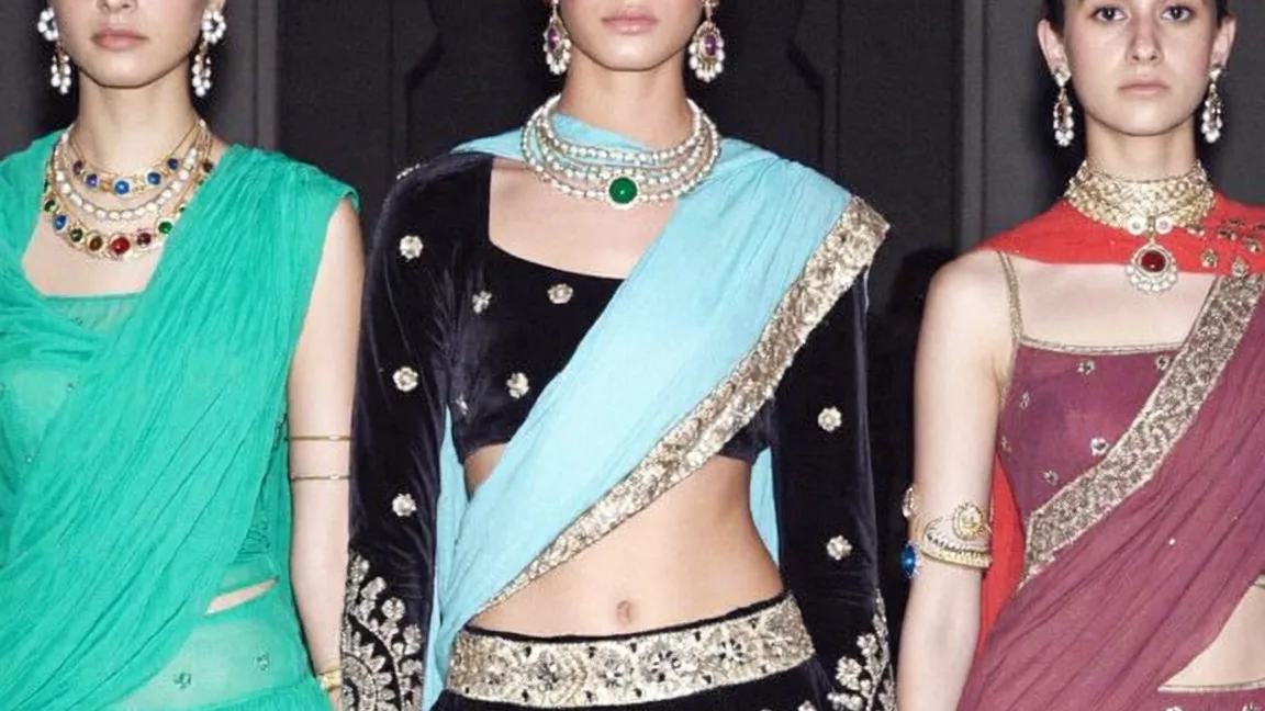 Three saris in jade, black velvet and rose, gold-bordered, under a scalloped arch