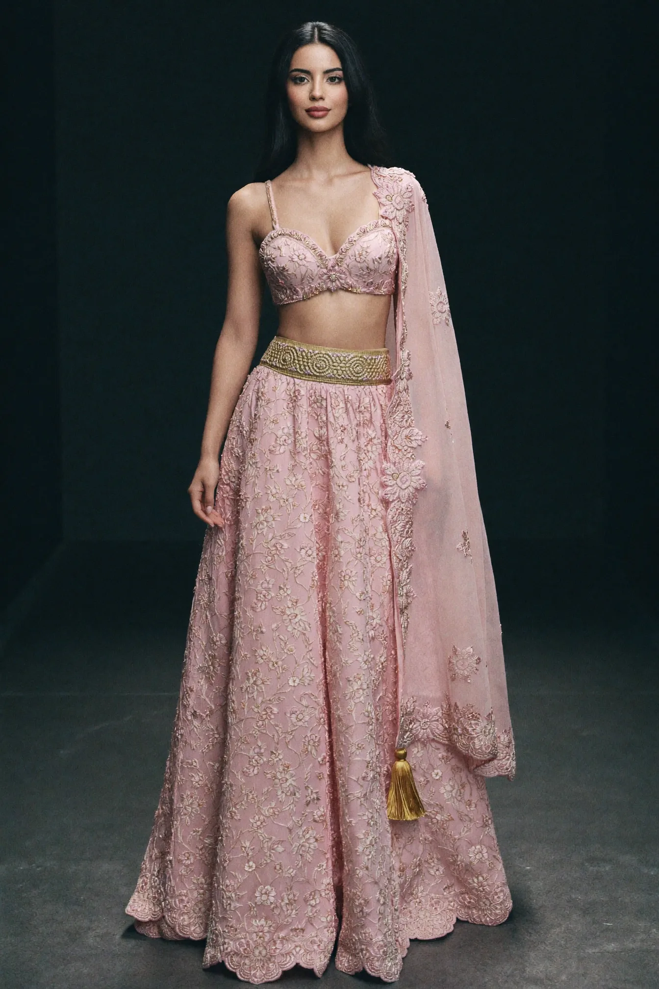 A pale rose lehenga in dense white chikan floral work with a gold waistband